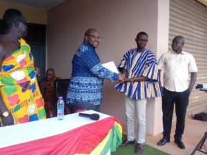 : Dr Kojo Asante (left) presenting a copy of the signed policy document to Mr Mensah.     