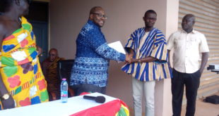 : Dr Kojo Asante (left) presenting a copy of the signed policy document to Mr Mensah.